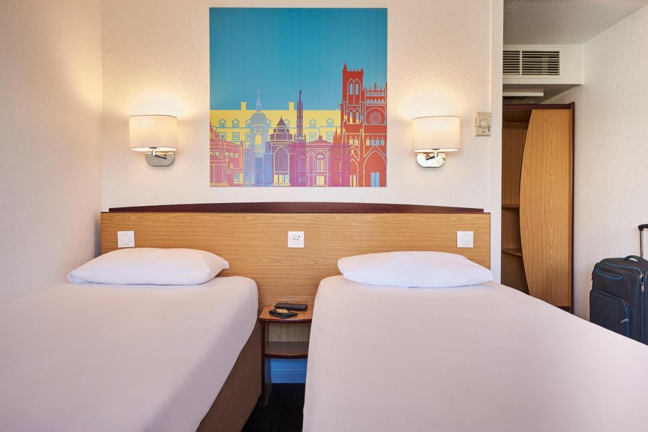 Chambre Triple (2 Lits Simples + 1 Lit Junior)